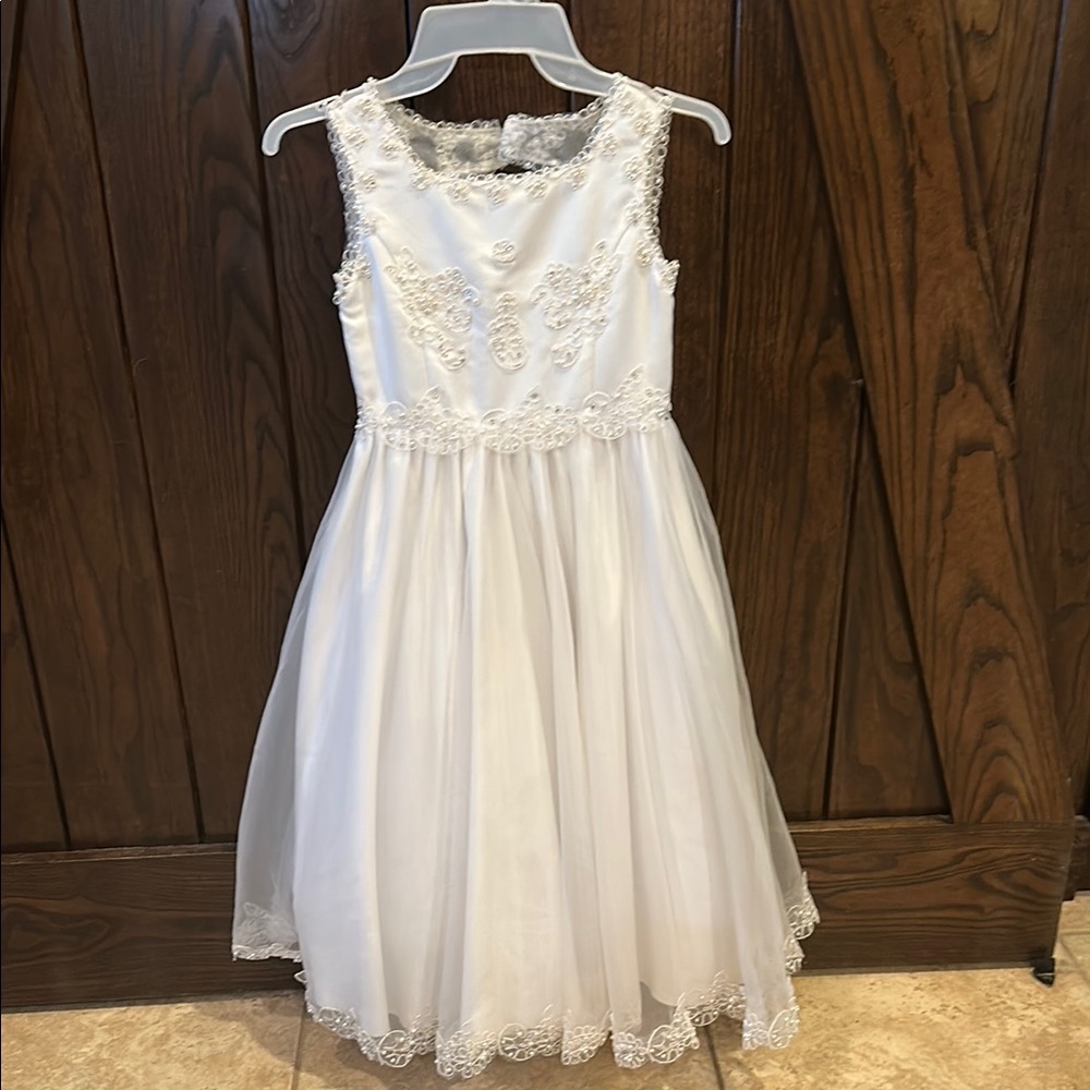 American Princess white with pearl, rhinestone and lace accents.